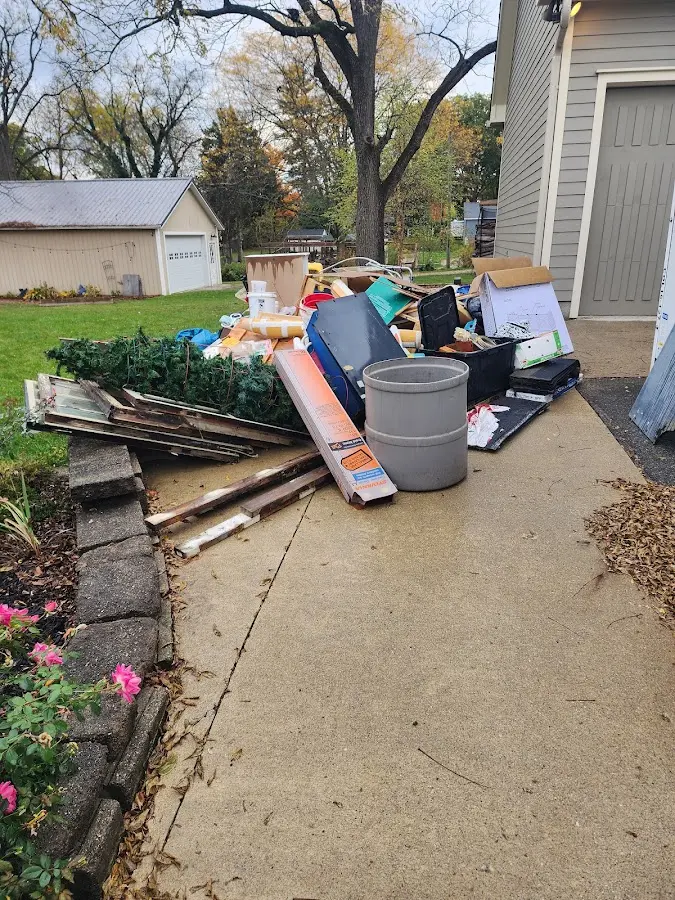 Dumpster being loaded with debris for 12 Yard Dumpster Rental in Rosaryville